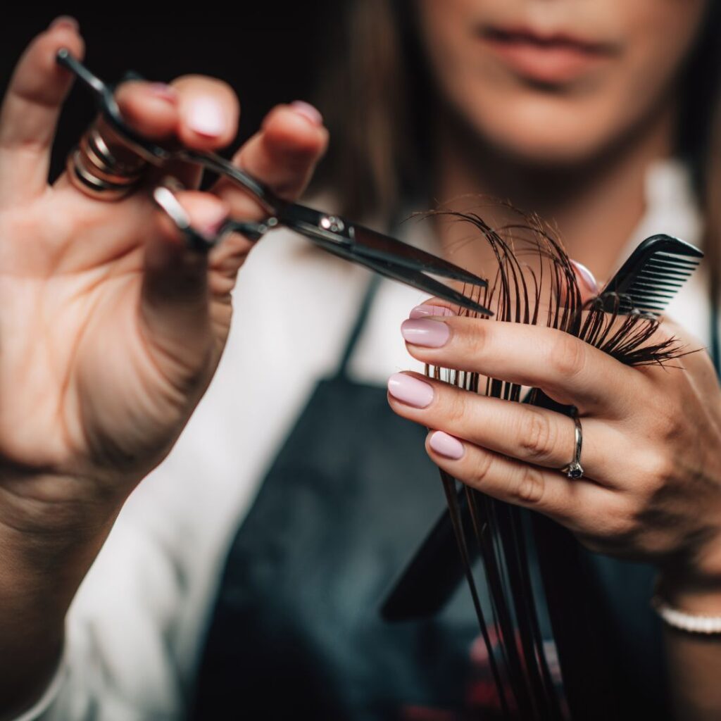 Hair dresser cutting hair.